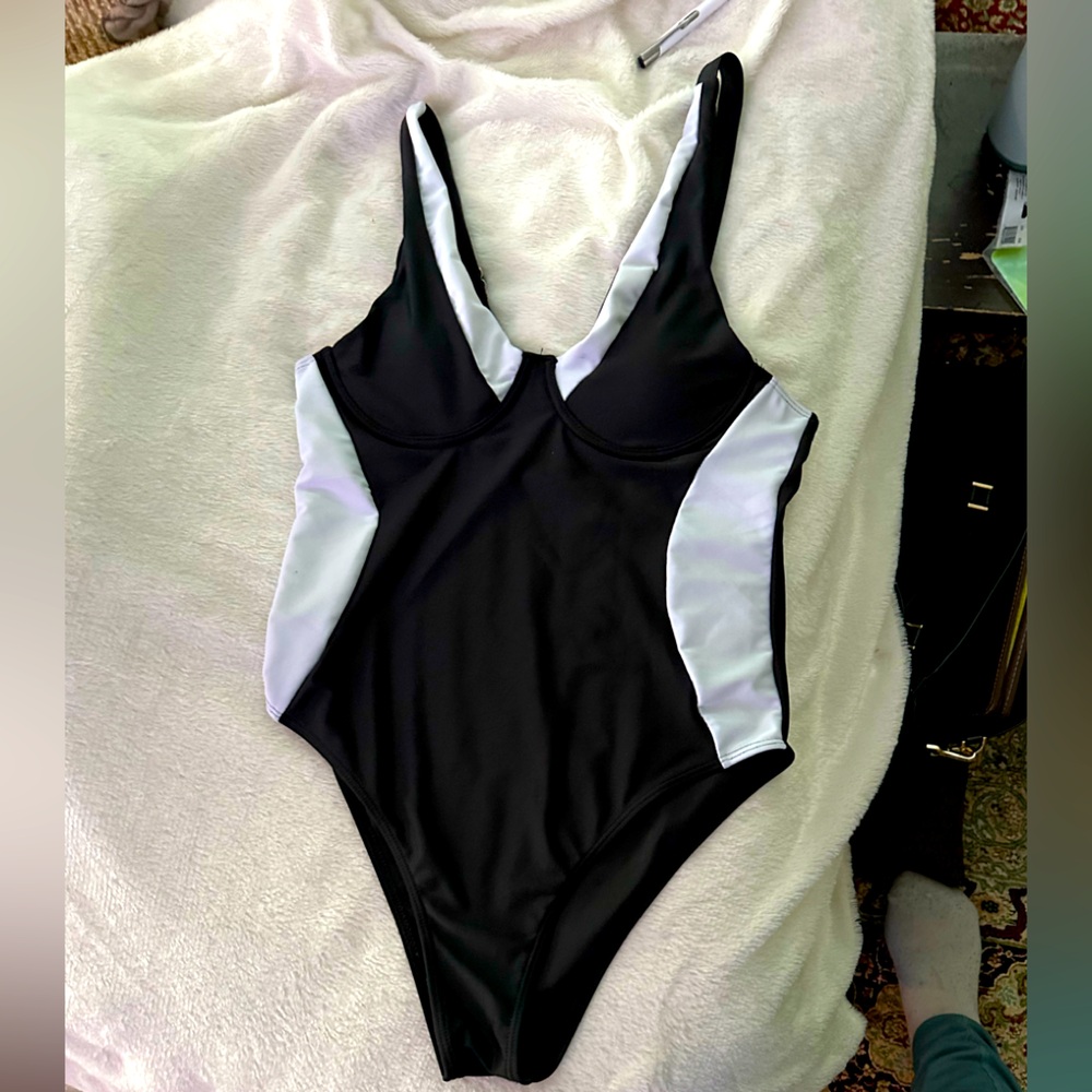 Black and white color blocked one piece bathing suit with underwire.